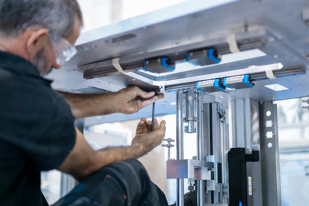 A service technician servicing lab equipment. 