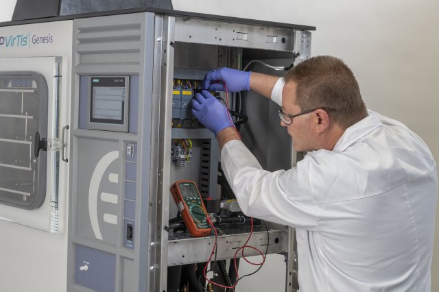 A service technician servicing lab equipment.